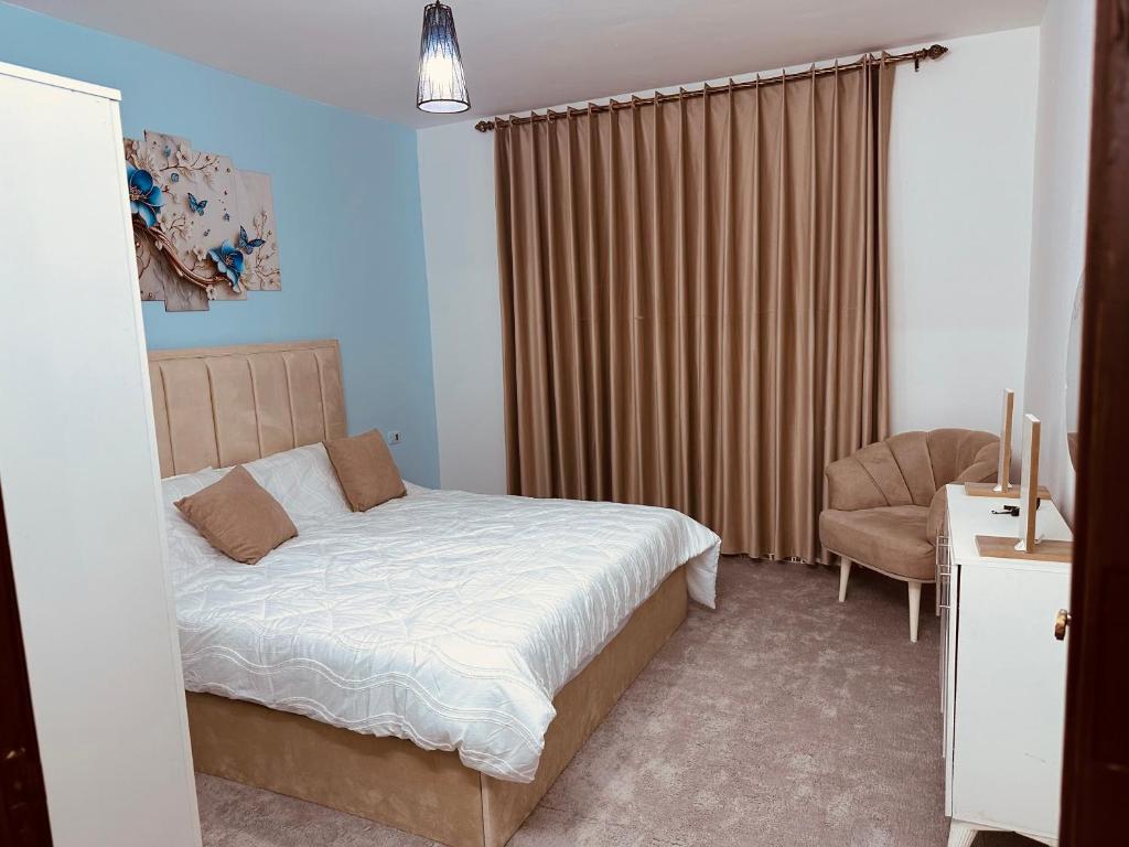 a bedroom with a bed and a chair at Furnished Two bedroom apartment in Irbid in petra st in Irbid