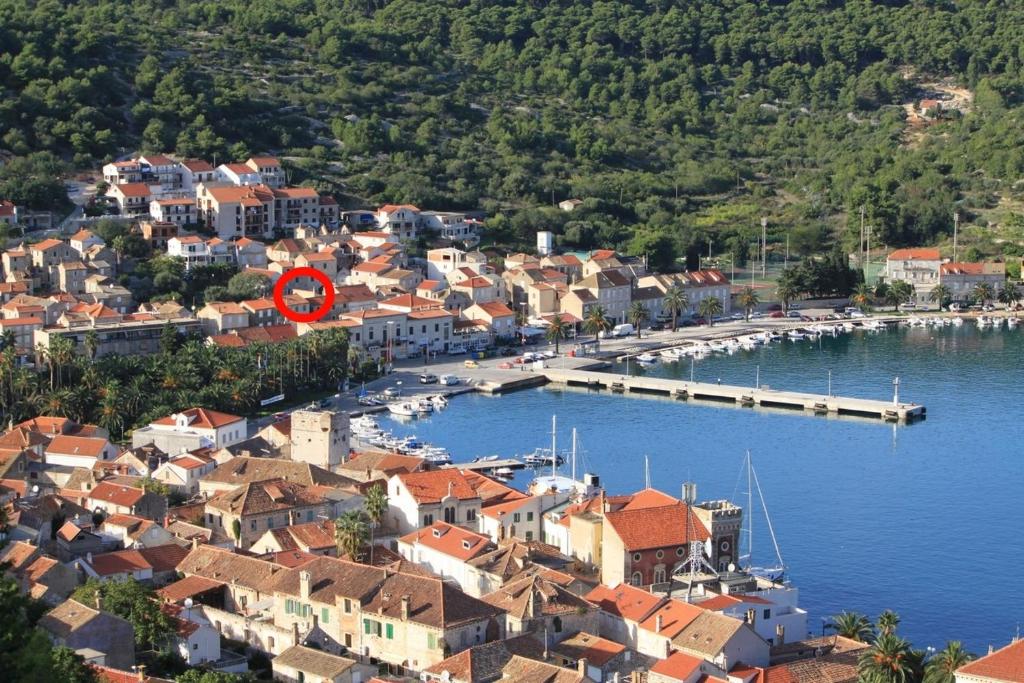 a town with a marina with a red circle on it at Apartments by the sea Vis - 2457 in Vis