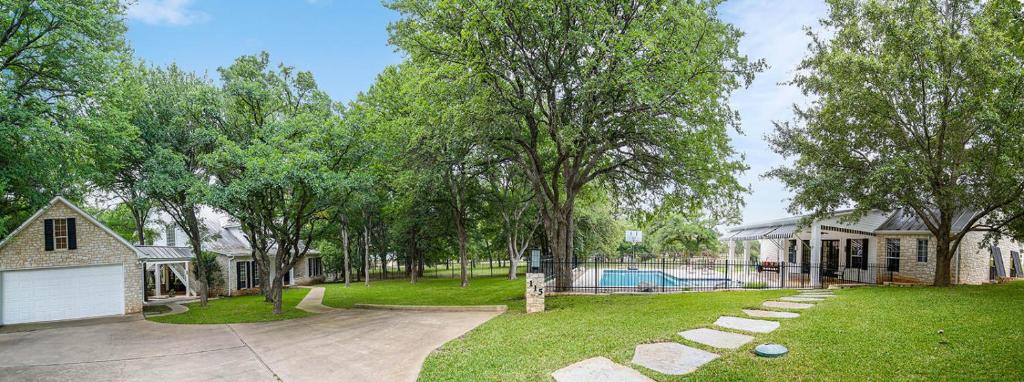 a yard with a house and a pool at Luxury Golf Course Private Retreat with Heated Swimming Pool in Horseshoe Bay
