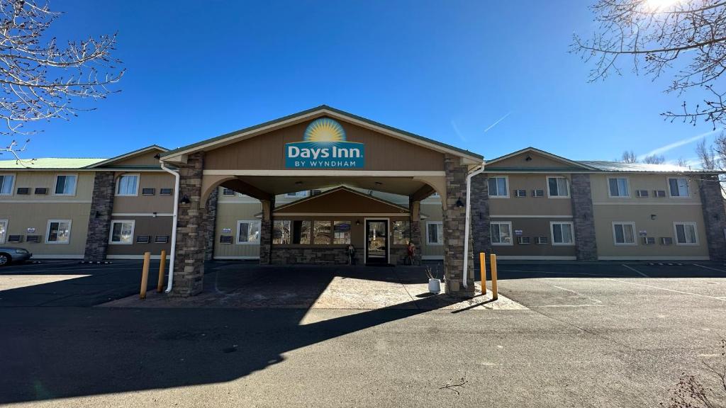 a building with a sign on the front of it at Days Inn & Suites by Wyndham Gunnison in Gunnison