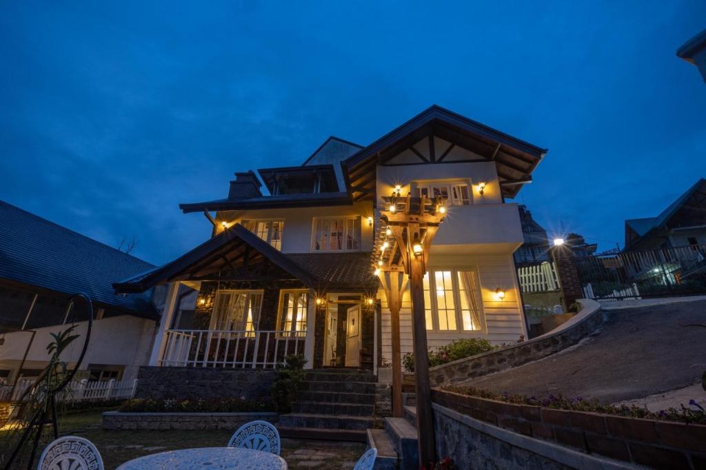 a house with a street light in front of it at The Tapherini Bungalow in Nuwara Eliya