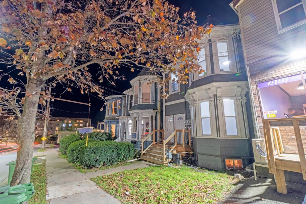 a row of houses on a street at night at Stylish Downtown Apartment in Halifax