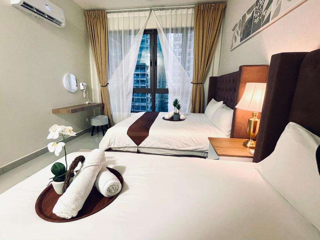 a hotel room with two beds and a window at Bali Residence PROMO PRICE W#APP NO BELOW in Malacca