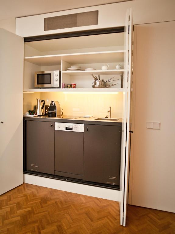 a room with a kitchen with a large pantry at CORTIINA Hotel in Munich