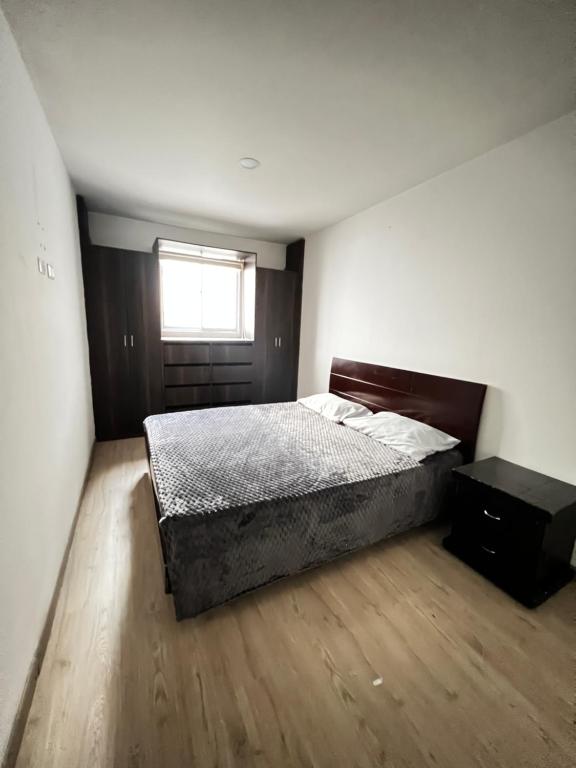 um quarto com uma cama e uma janela em Tomasa guest house em Bogotá