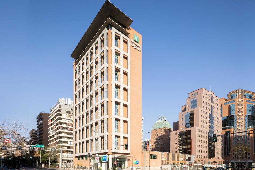 a tall building in a city with tall buildings at Holiday Inn Express Santiago Las Condes, an IHG Hotel in Santiago