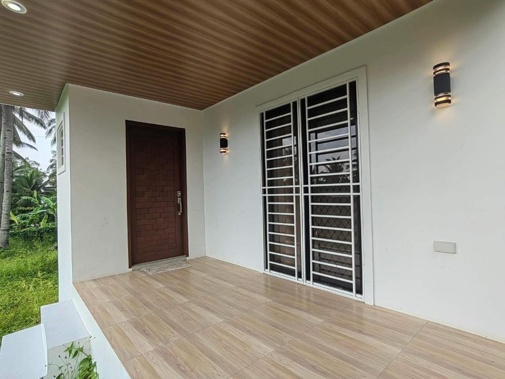 a house with a wooden floor and a wooden door at Chateau d' sentier in Davao City
