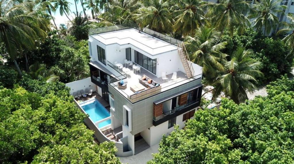 an aerial view of a house with a swimming pool at Unwind Dhigurah in Dhigurah