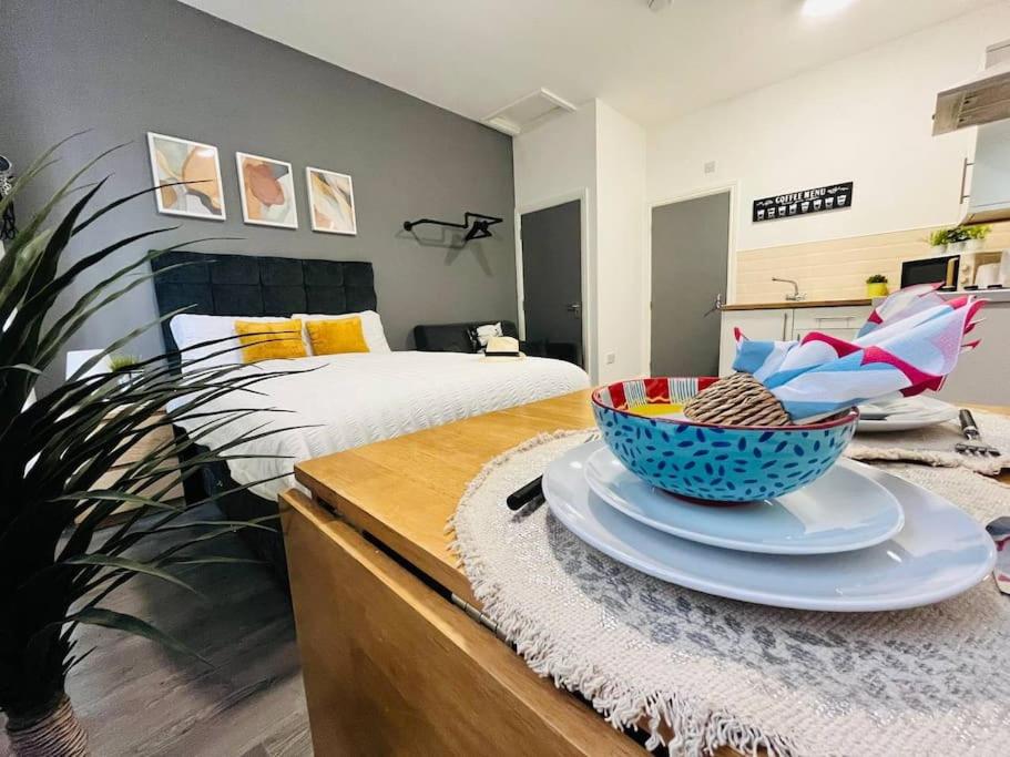 a bedroom with a bed and a bowl on a dresser at Urban and stylish Central Studio Apartment in Liverpool with high speed free wifi in Liverpool