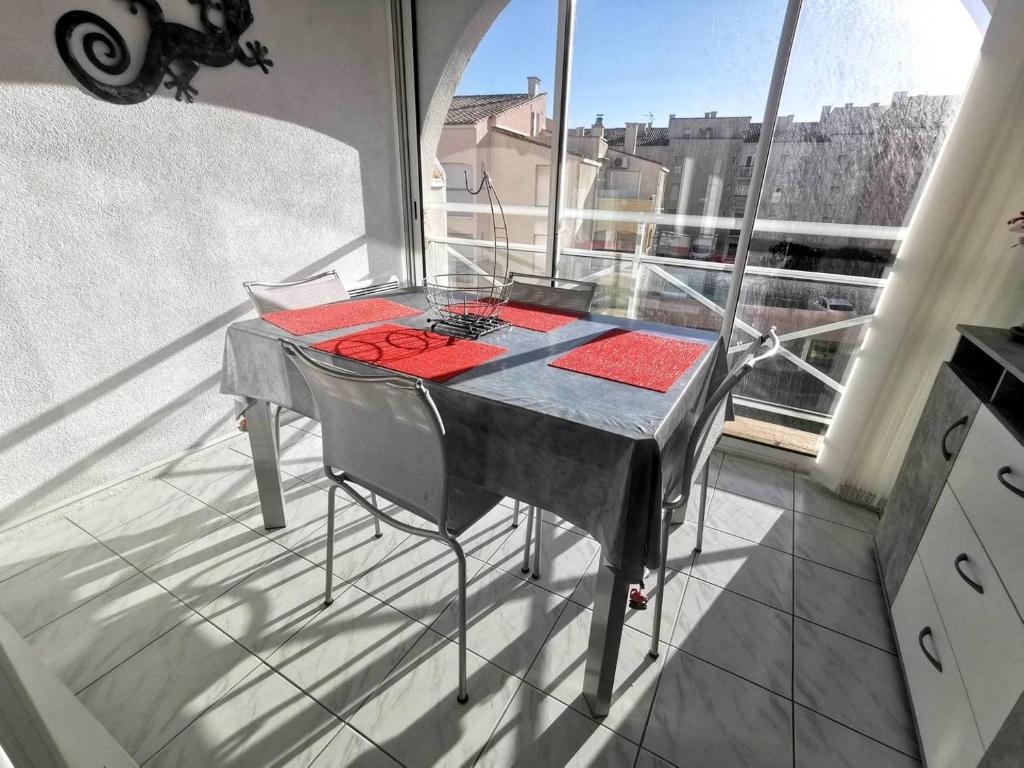 - une table sur un balcon avec vue sur un bâtiment dans l'établissement 039 Marina Bay 403, au Cap d'Agde