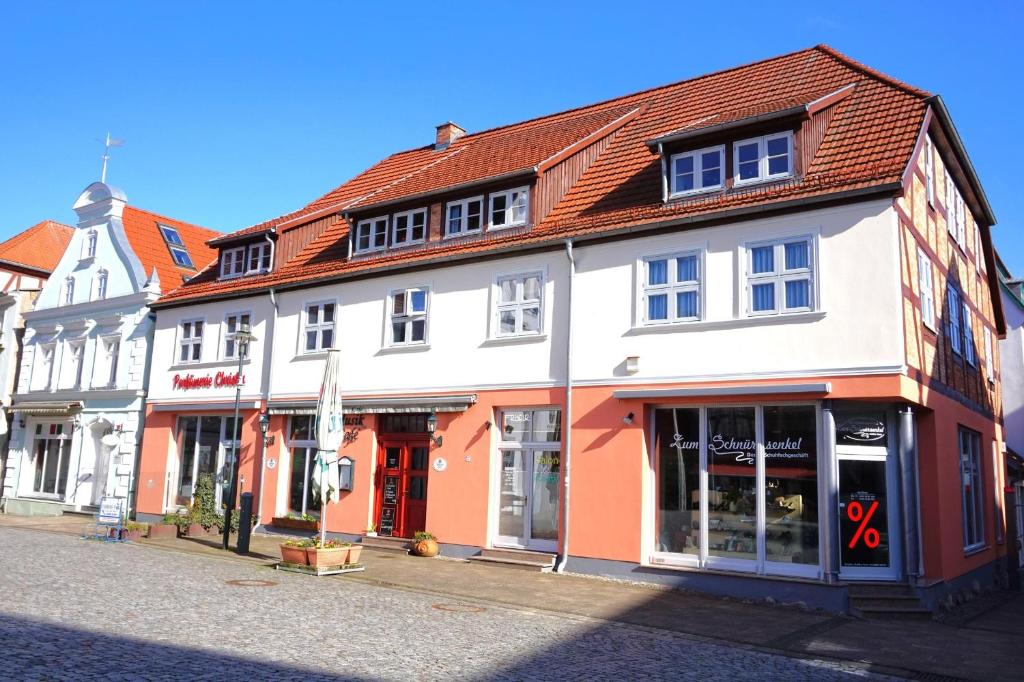 a white and orange building on a street at Fewo Wolgast Usedom Ostsee in Wolgast