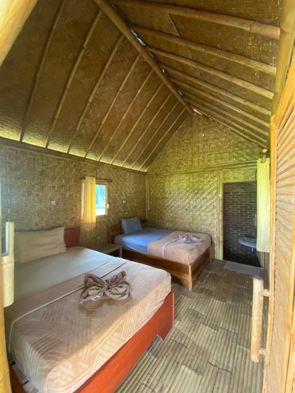 Postel nebo postele na pokoji v ubytování EDRIAN BUNGALOWS