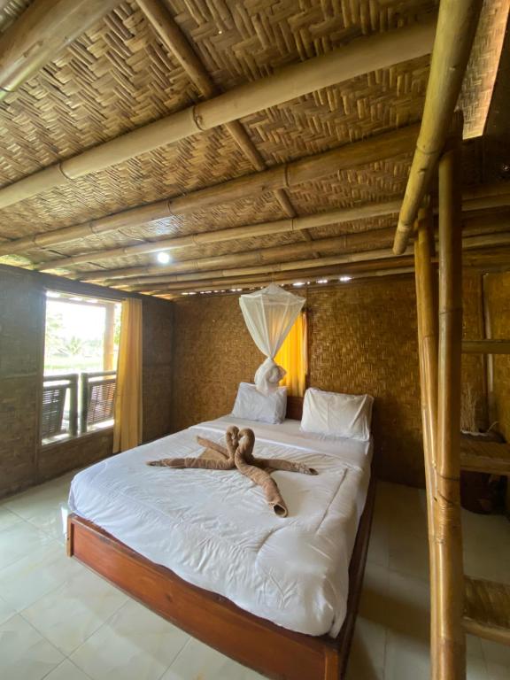 Postel nebo postele na pokoji v ubytování EDRIAN BUNGALOWS