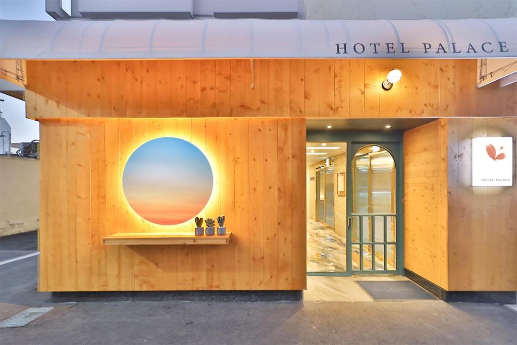 a building with a window with a sunset on it at Hotel Palace Gyeongju in Gyeongju