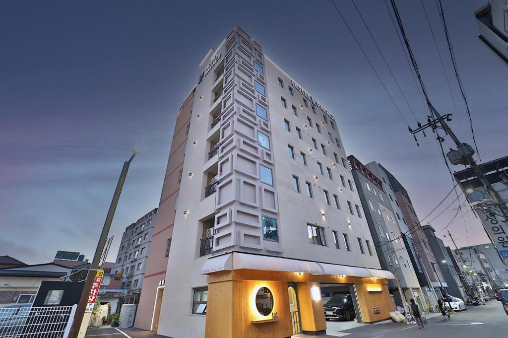 a tall building on the corner of a street at Hotel Palace Gyeongju in Gyeongju