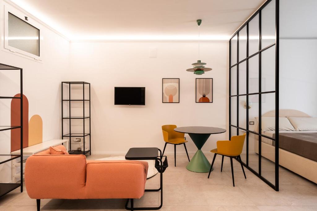 a room with a bed and a table and chairs at Loft 404 by Wonderful Italy in Bari