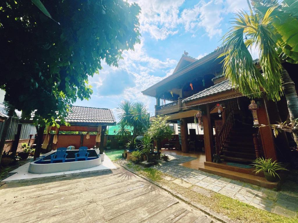 uma casa com um barco à sua frente em 泰小院儿（99 Friend’s house Lanna ) em Chiang Mai