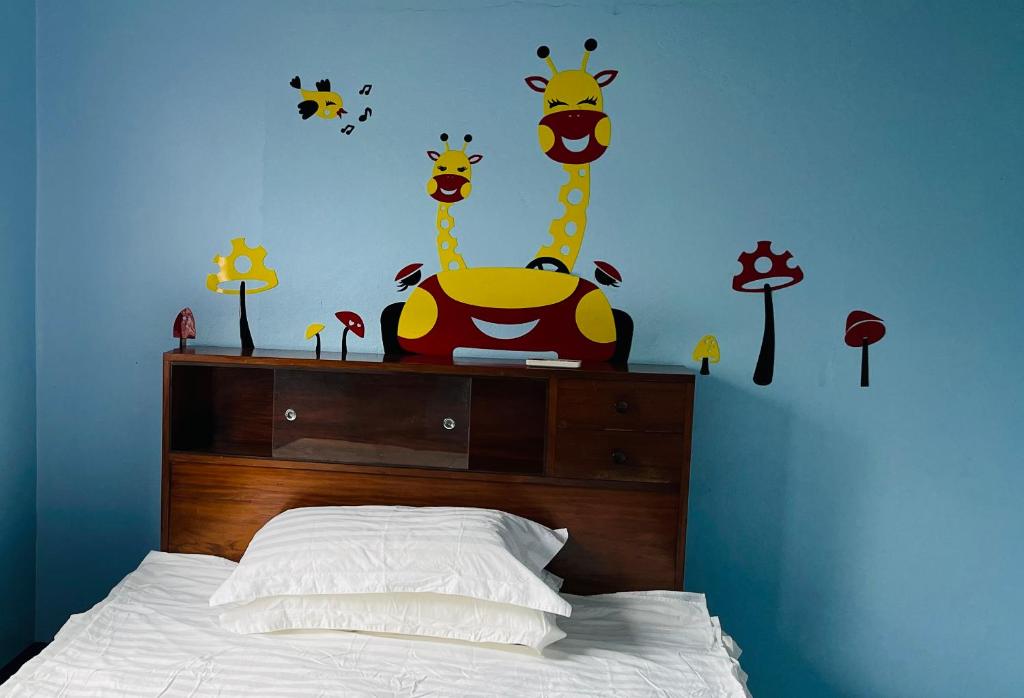 a bedroom with a bed with giraffes on the wall at Grace house in Suva