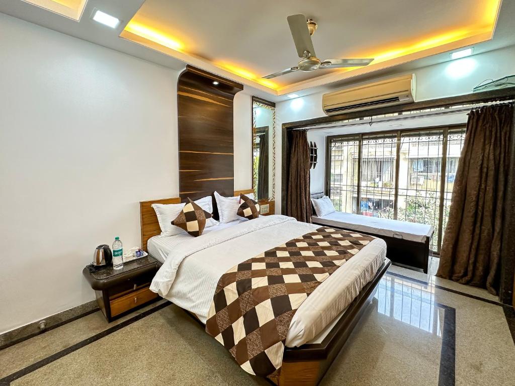 a bedroom with a large bed and a window at Welcome Home Service Apartments - Andheri in Mumbai