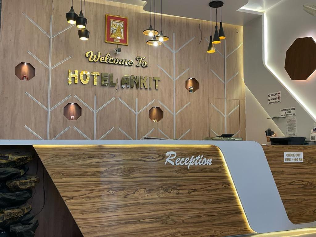 a hotel lobby with a reception desk with a sign on the wall at Hotel Ankit Near Assi Ghat in Varanasi