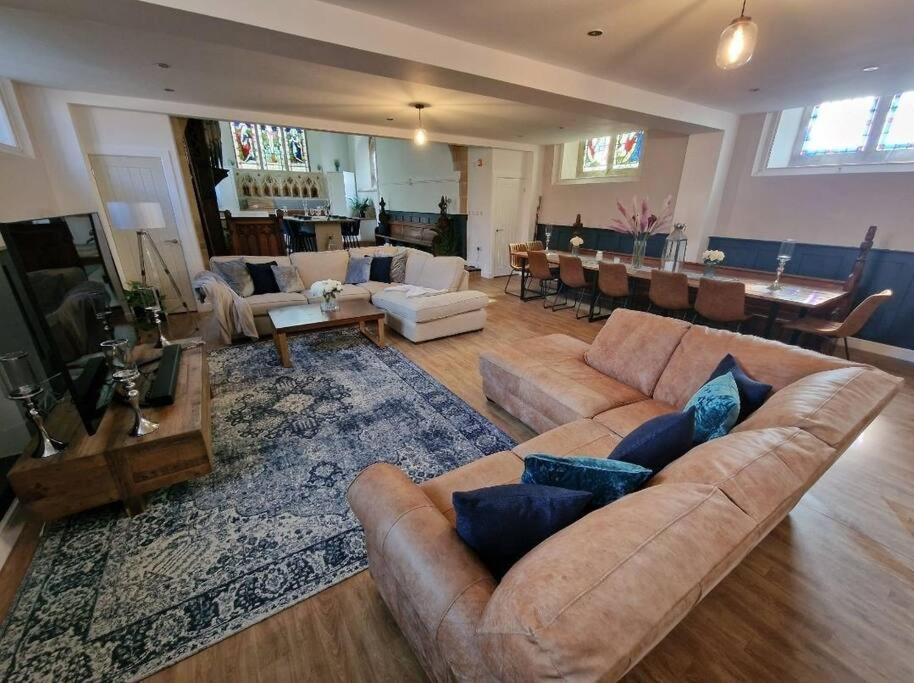 a large living room with couches and a dining room at Peaceful Church Getaway in Middleton One Row