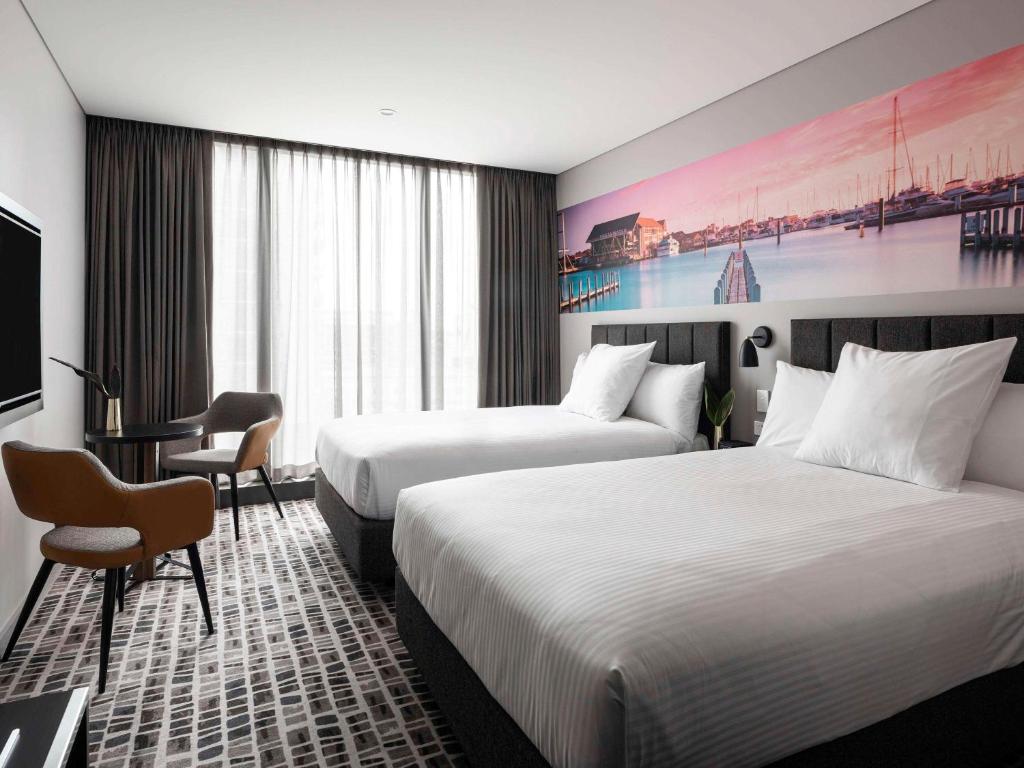 Ein Bett oder Betten in einem Zimmer der Unterkunft Novotel Perth Murray Street