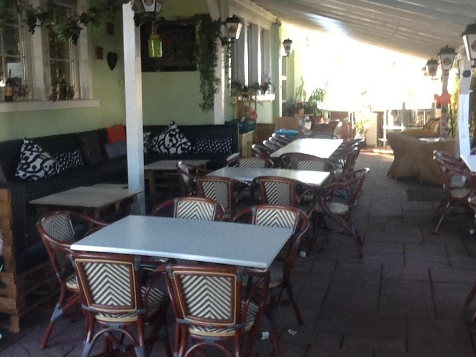 a group of tables and chairs in a restaurant at Hotel Restaurant Anna in Ramstein-Miesenbach