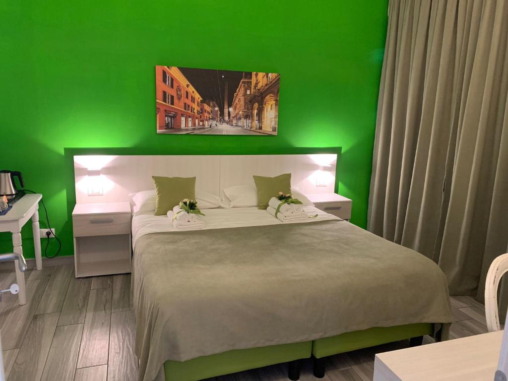 a green bedroom with a bed with a green wall at Bed End Breakfast Mary's Tower in Bologna