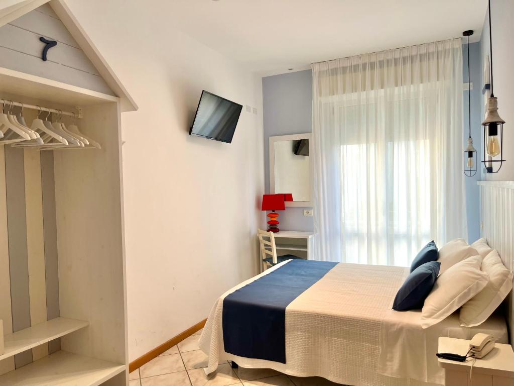 Postel nebo postele na pokoji v ubytování Hotel Acquario