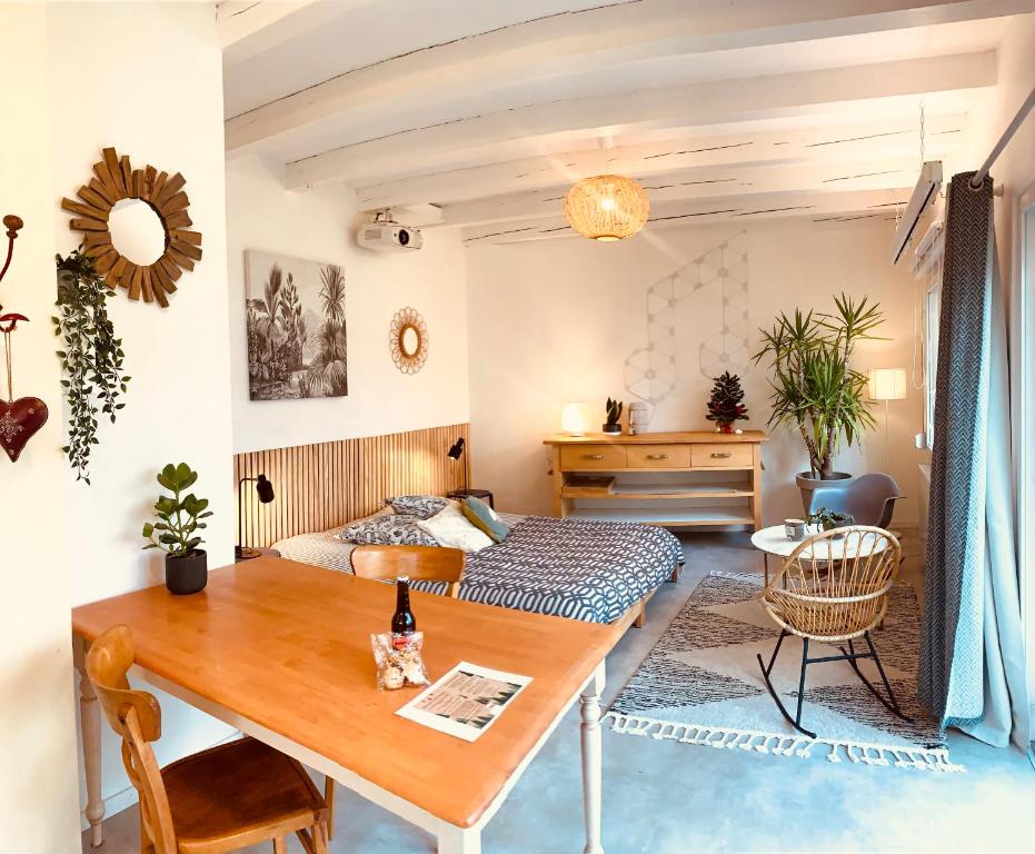 a bedroom with a bed and a table in a room at Gîte Mozart - Marché de Noël in Colmar