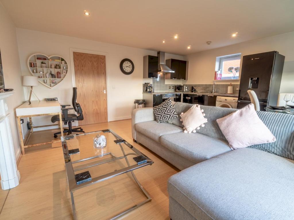 a living room with a couch and a glass table at Pass the Keys Super luxurious 2 bedroom apartment in Nottingham