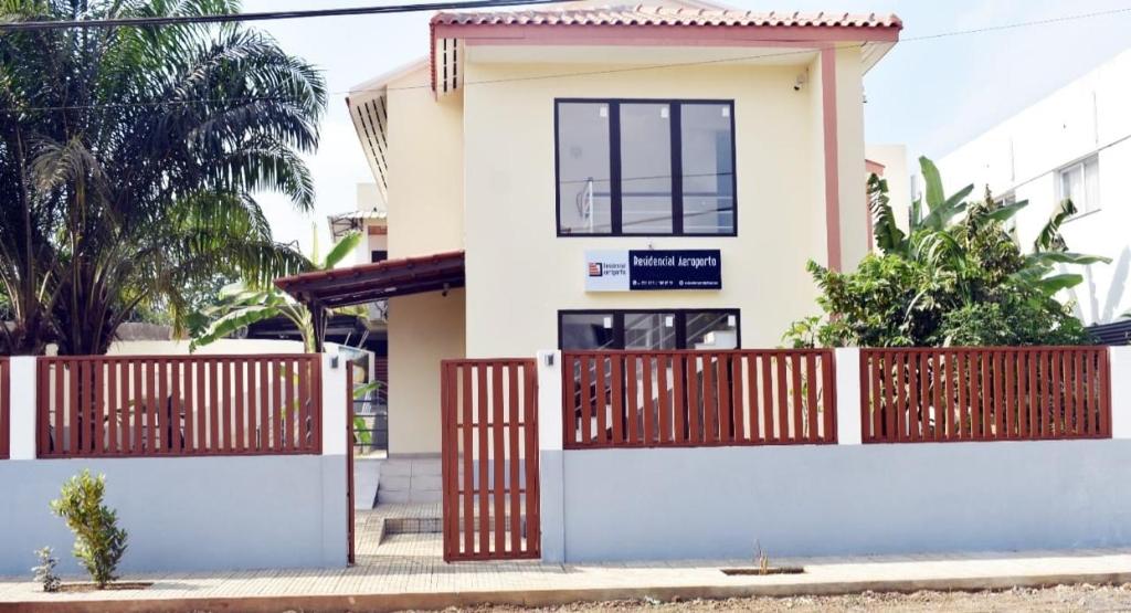 a house with a gate in front of it at Residencial Aeroporto in São Tomé