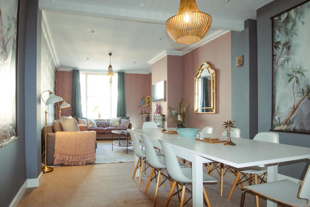 a dining room with a white table and chairs at Bridge Street Rows City Centre Apartment by Rework Accommodation in Chester