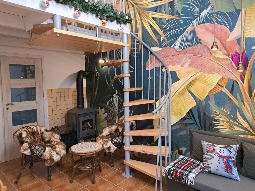 a living room with a spiral staircase and a mural at Brzozowy Zakątek in Bochnia