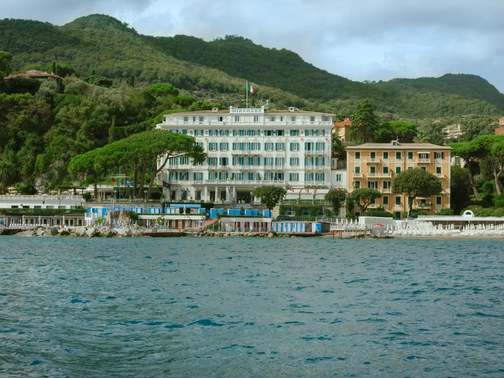 a large white building on the shore of a body of water at Grand Hotel Miramare in Santa Margherita Ligure
