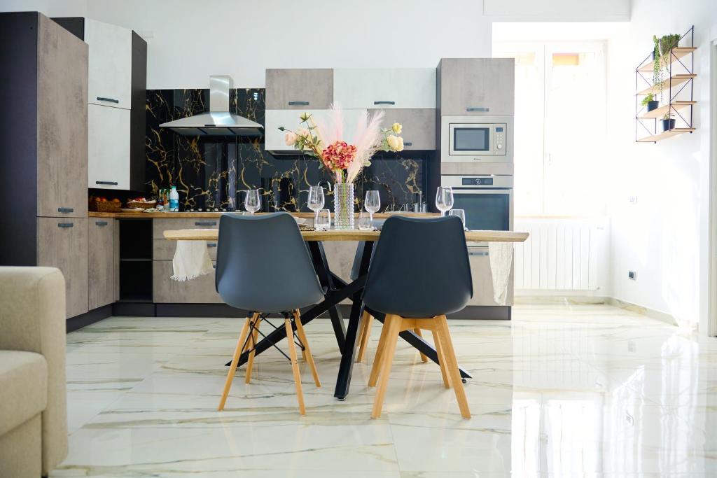 a kitchen with a table and two chairs at GG HOME in Saviano