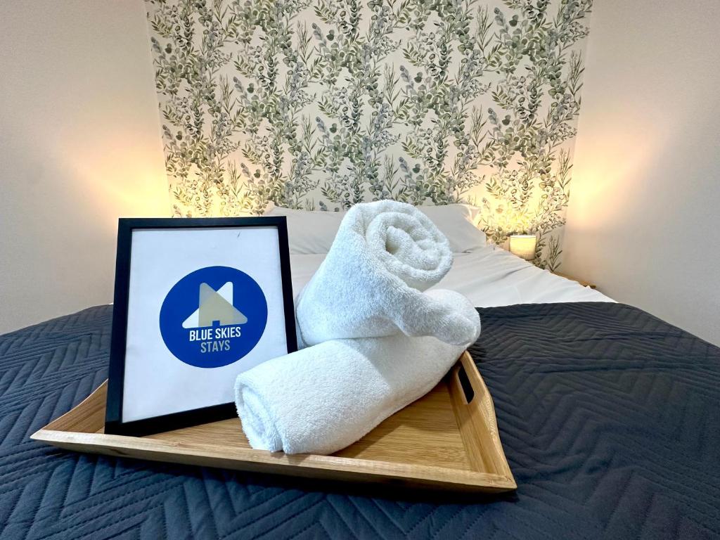 a towel sitting on a tray on a bed at Whessoe House by Blue Skies Stays in Stockton-on-Tees
