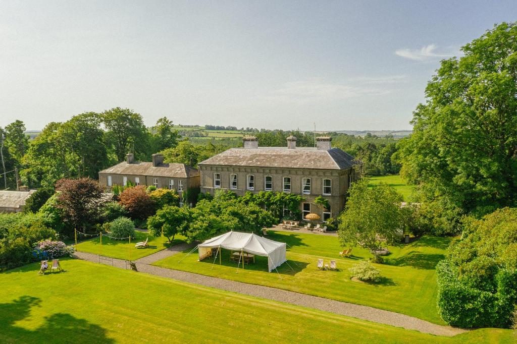 an aerial view of a large house with a tent at Ballyvolane House in Fermoy