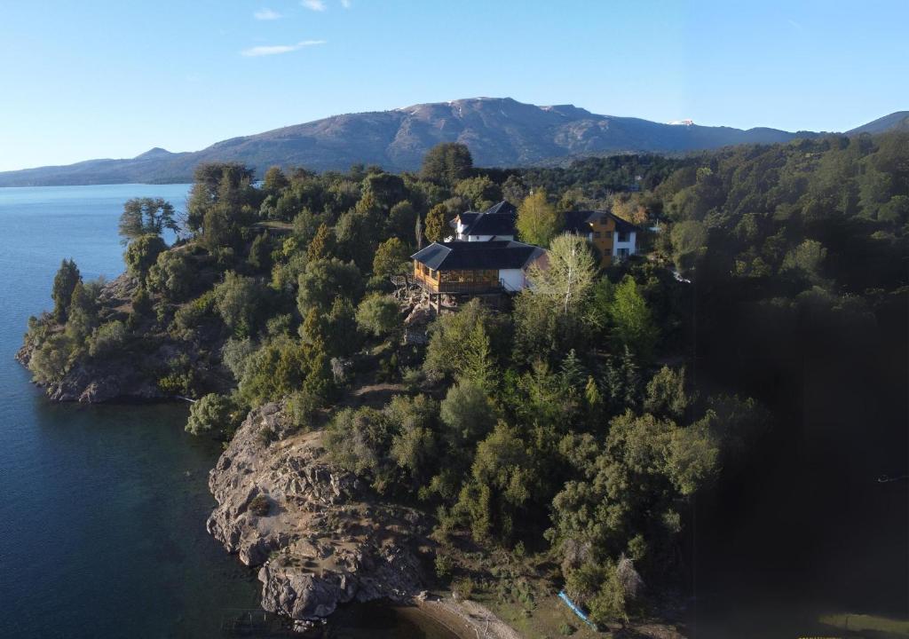 an aerial view of a house on a rocky island in the water at La Balconada by DOT Boutique in Villa Pehuenia