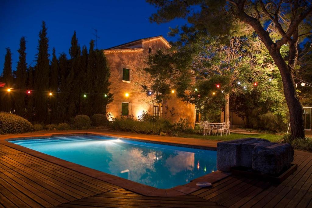 a swimming pool in front of a house at night at Catalunya Casas Rustic Vibes Villa with private pool 12km to beach in Vilafranca del Penedès