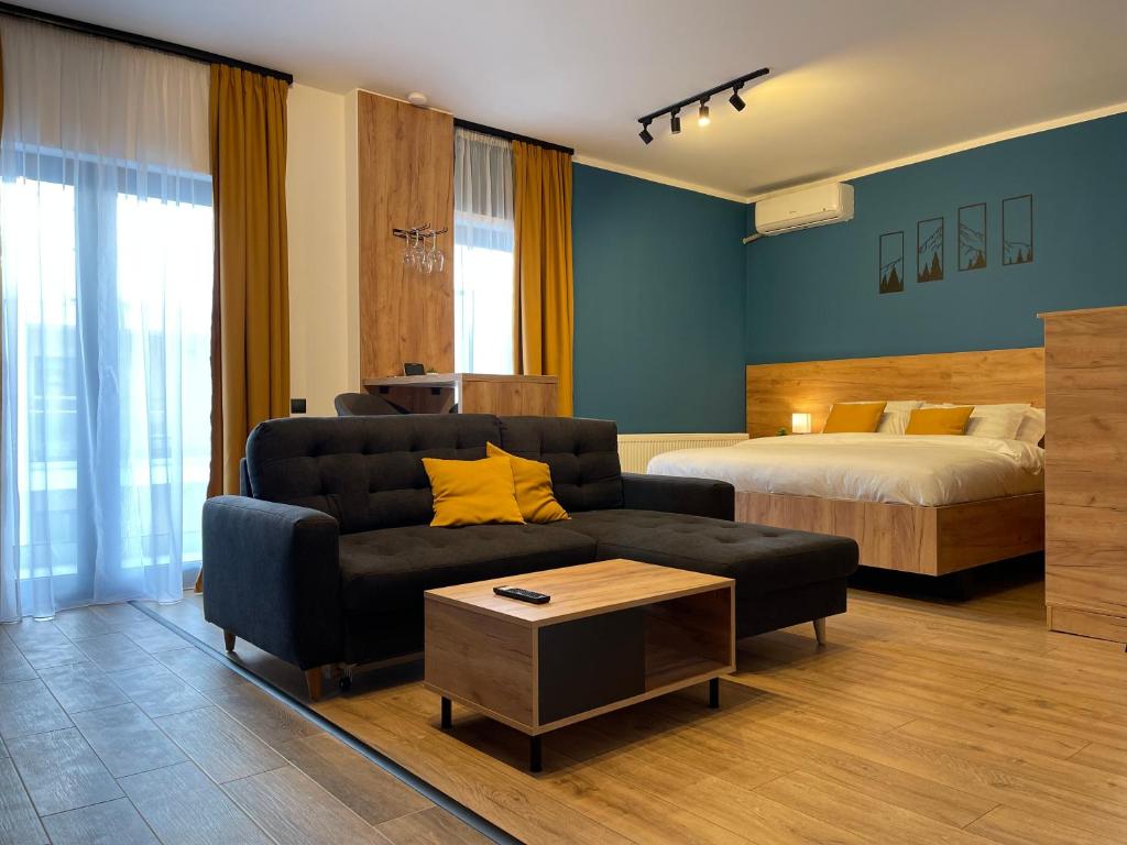 a living room with a couch and a bed at 1320 Apartments in Sibiu