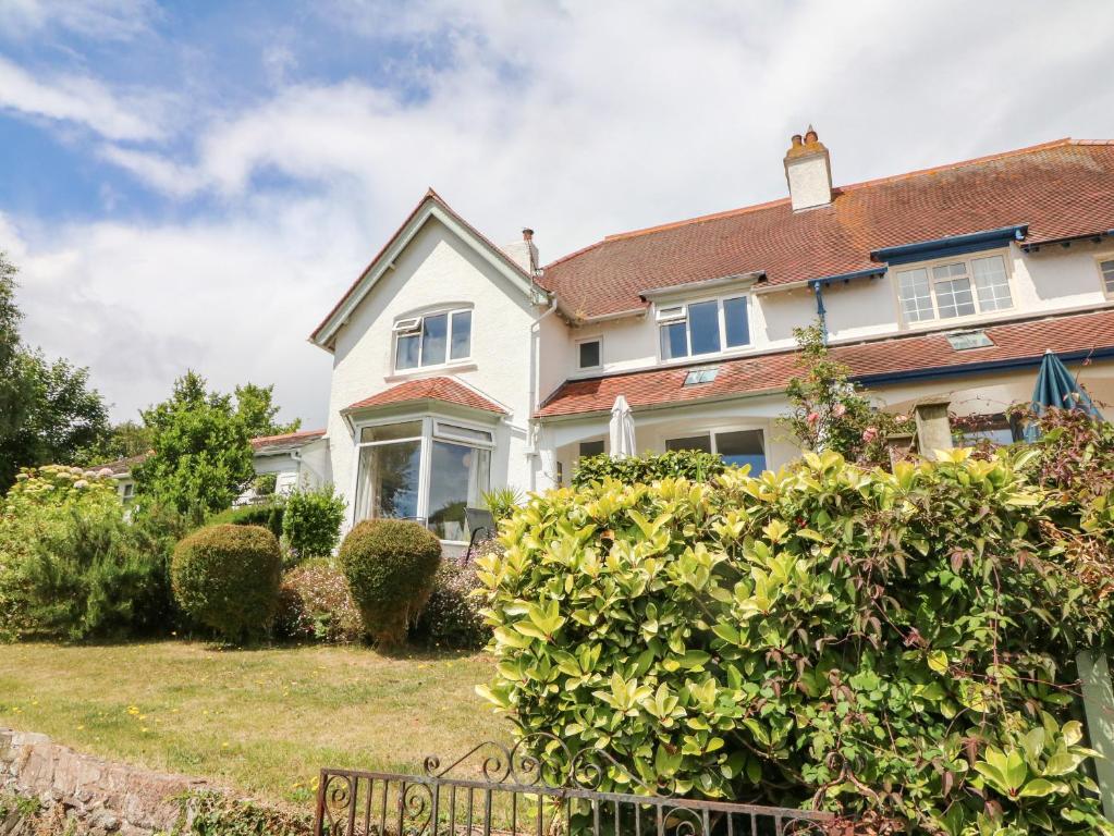 a large white house with a yard at 2 Moorlands in Minehead