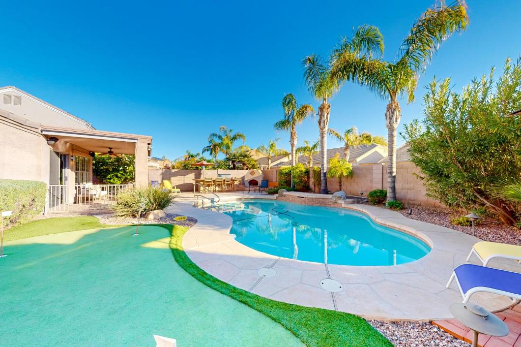 a swimming pool in a yard with palm trees at Desert Dream in Cave Creek