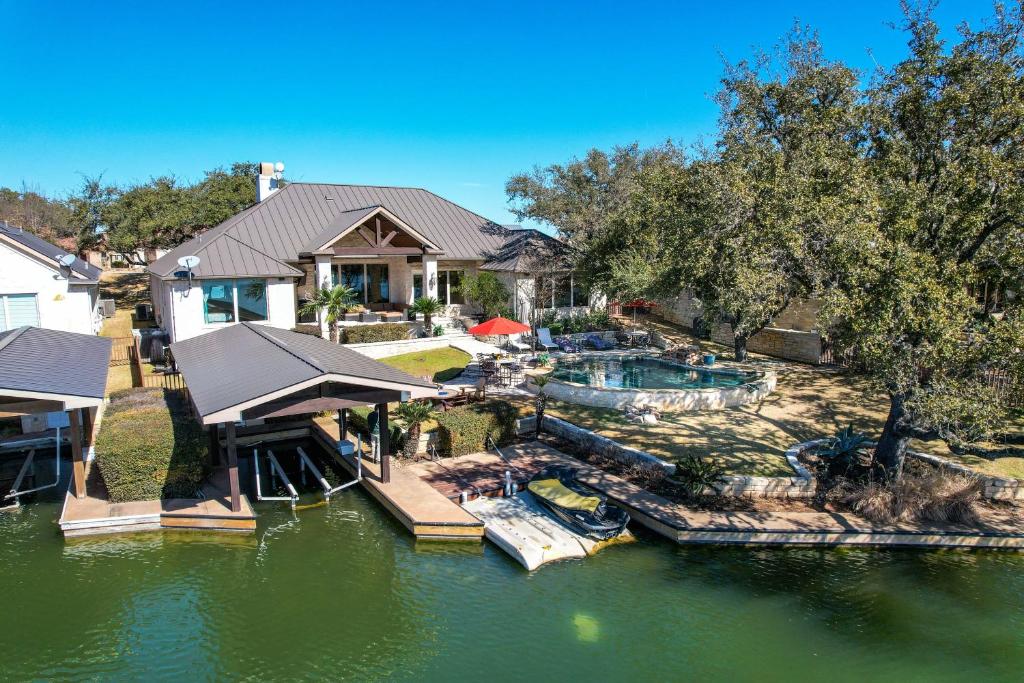 an aerial view of a house with a swimming pool at Stunning Lakefront Retreat Pool Boat Lift Spectacular Views in Horseshoe Bay