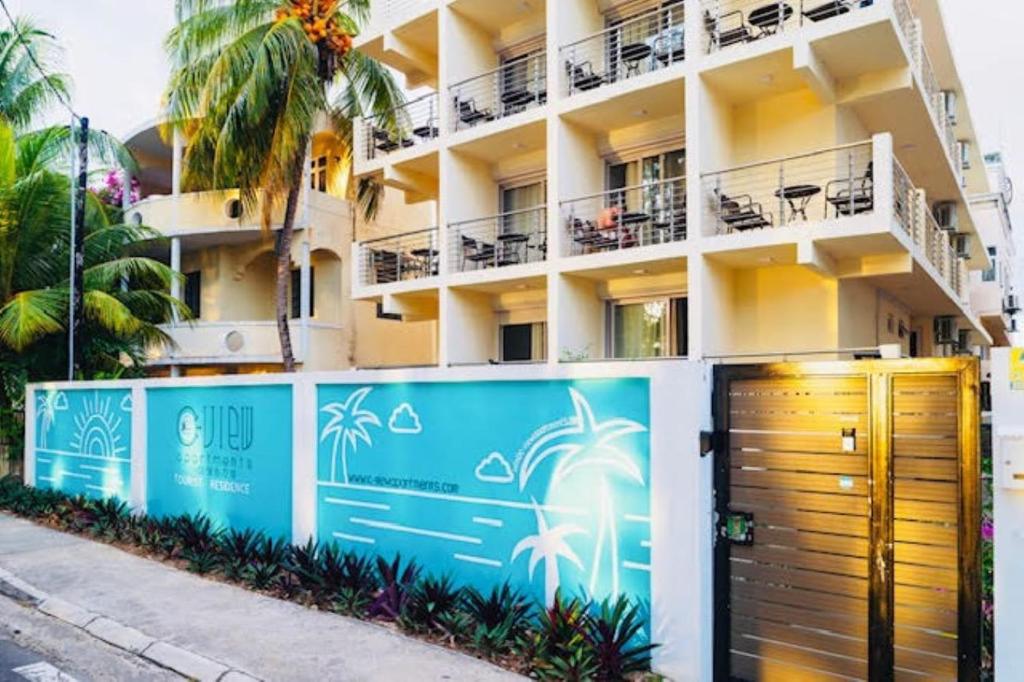a building with a gate in front of it at C-view Apartments in Flic-en-Flac