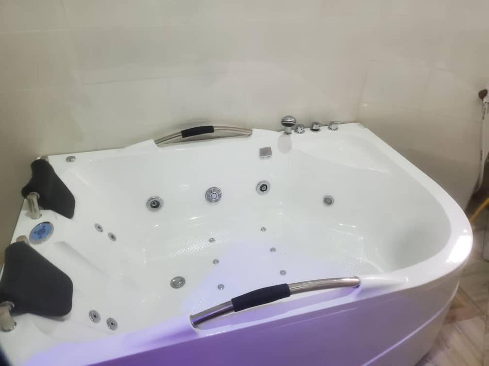 a white bath tub sitting in a room at M View Hotel in Benin City