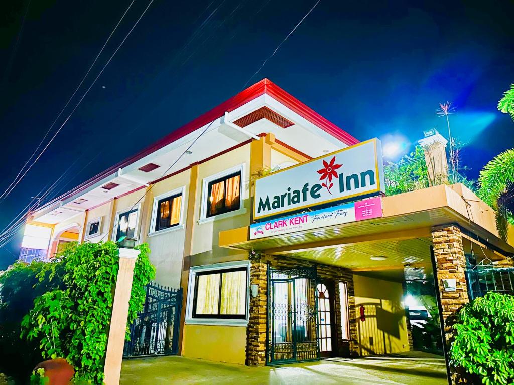 a building with a sign that reads market inn at Mariafe Inn in Puerto Princesa City