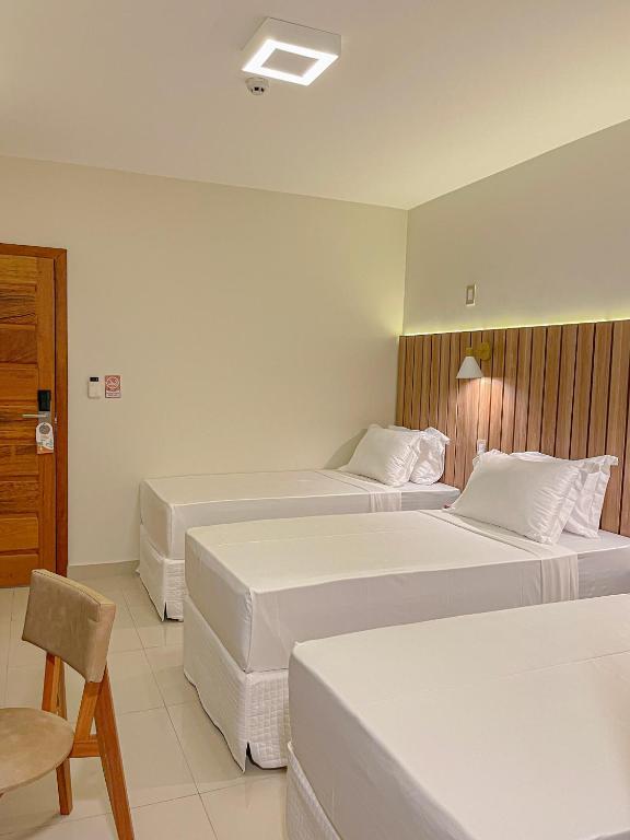Postel nebo postele na pokoji v ubytování Principe do Mutá Hotel Design