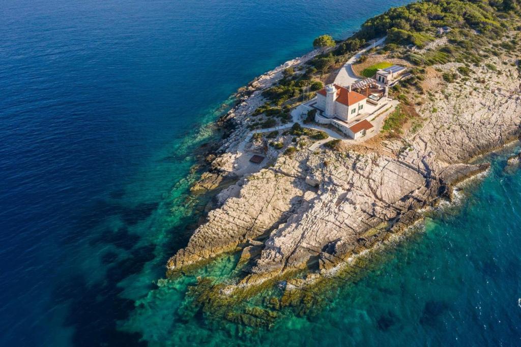 an aerial view of a house on an island in the ocean at Luxury seafront Villa Lighthouse Ligero on Host island - Vis island in Vis