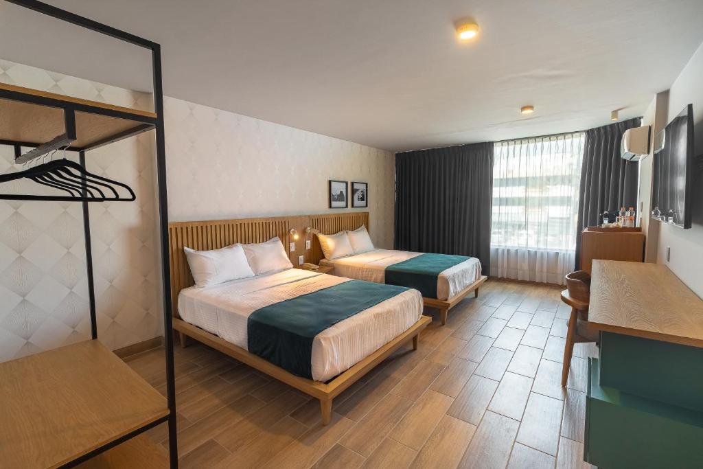 Postel nebo postele na pokoji v ubytování Oliva Plaza Hotel